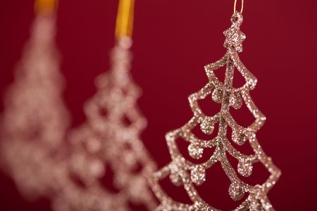 background made of hanging christmas decoration over a red background (very shallow deep)の写真素材