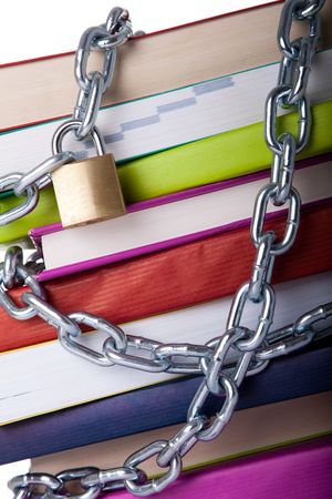 stack of colorful books protected with a chain (over a white background)の写真素材