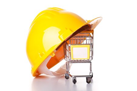 construction helmet over a shopping cart (isolated on white)の写真素材