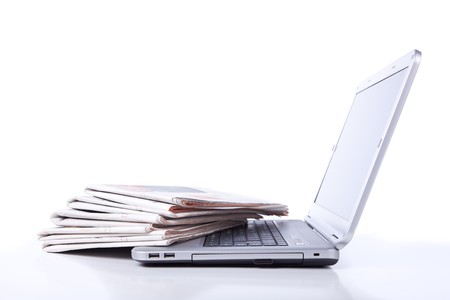 stack of newspaper over a laptop (selective focus)の写真素材