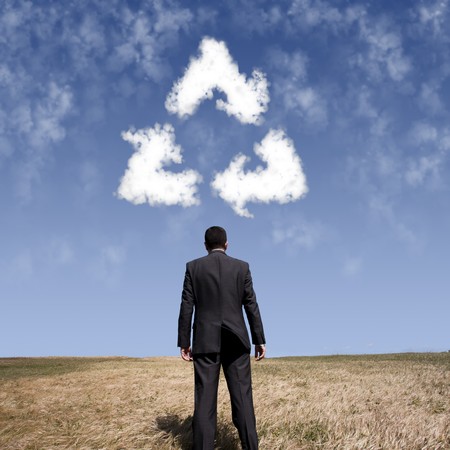 businessman looking the recycle shape clouds at the field