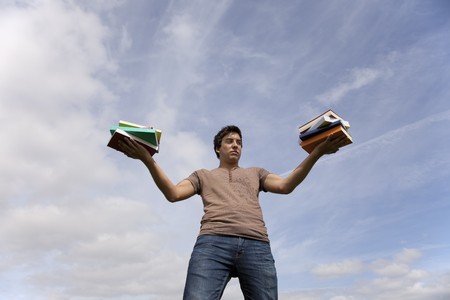 Young men holding school books and looking away