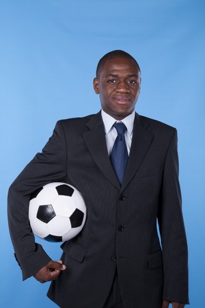 African businessman holding a soccer ballの写真素材