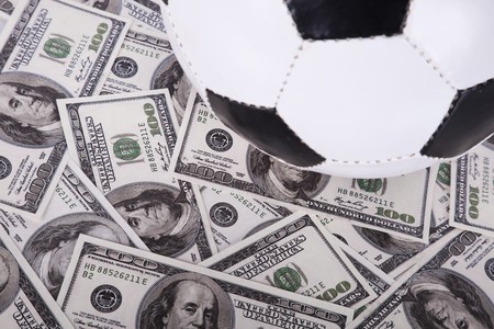 soccer ball over a lot of money (selective focus)の写真素材