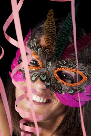 beautiful woman celebrating with a seductive maskの写真素材