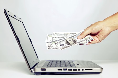 hand gesture next to a laptop  with cross processing effect (selective focus)の写真素材