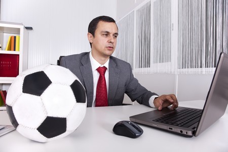 Mature football businessman manager working at the officeの写真素材