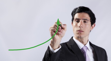 Modern businessman writing the business stats progress in the whiteboard (selective focus)の写真素材