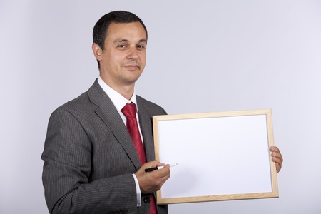 businessman holding a blank whiteboard