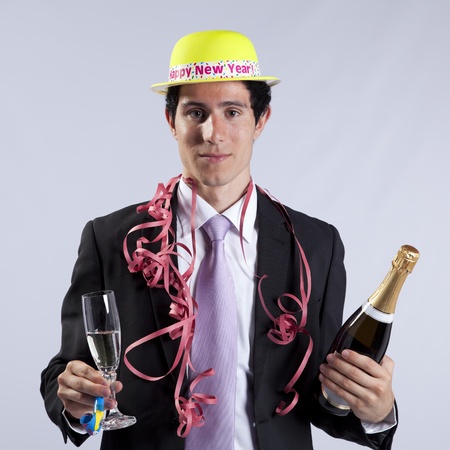businessman celebrating the new year eve with champagne (isolated on black)の写真素材