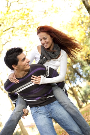 Young couple having a good time together at the park (selective focus with shallow DOF)の写真素材