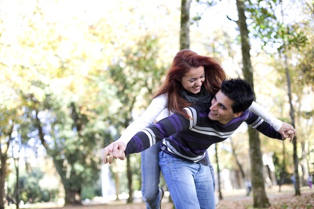 Young couple having a good time together at the park (selective focus with shallow DOF)の写真素材