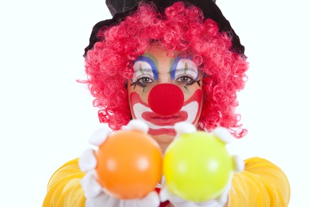funny clown holding color balls (isolated on white)の写真素材
