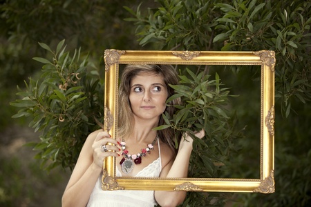 Beauty young woman posing at the forest (selective focus)の写真素材