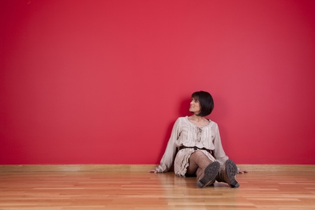 mature women sited in the floor of his new houseの写真素材