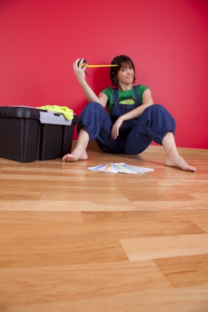 woman relaxing at her house after repairing her red wallの写真素材