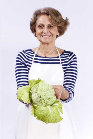 Beautiful senior woman holding a sproutの写真素材