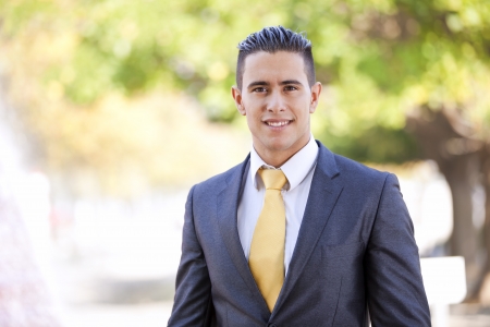Happy young businessman at the city parkの写真素材