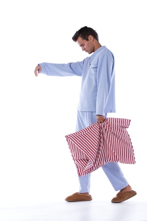 Young man sleepwalking dress with nightclothes (isolated on white)の写真素材