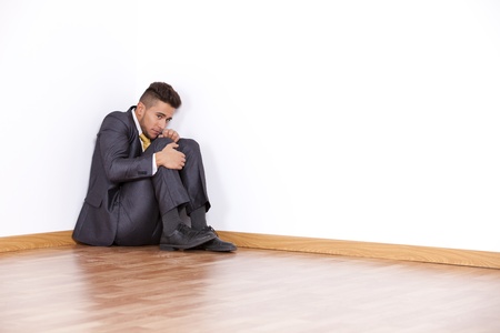 Businessman at the corner of his office room with fear
の写真素材