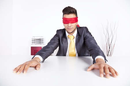 Businessman at his office with scarf covering his eyesの写真素材