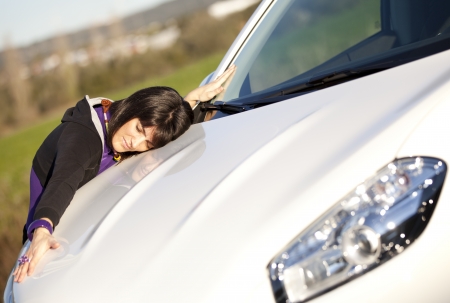 Beautiful woman embracing her new carの写真素材