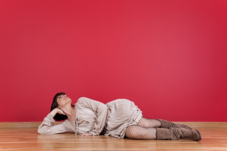 happy mature women laying down in the floor of his new houseの写真素材