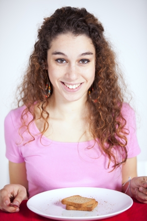 Young beautiful woman eating her morning toastの写真素材