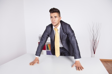 Modern and powerful businessman at his officeの写真素材