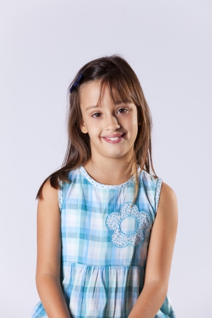 Happy little girl portrait (isolated on gray)の写真素材