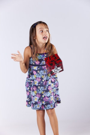 Happy little girl holding a gift boxの写真素材