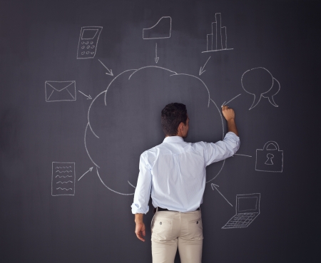 Businessman writing a cloud computing diagram on the chalkboard の写真素材