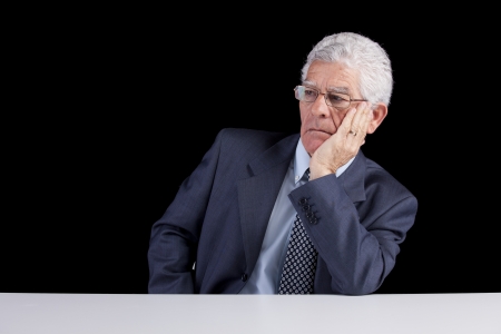 Senior businessman looking away to the copyspace (isolated on black)の写真素材
