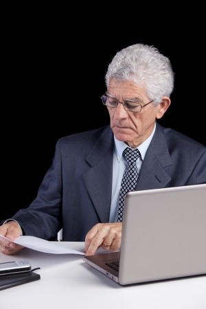 Senior businessman working with his laptop at his officeの写真素材