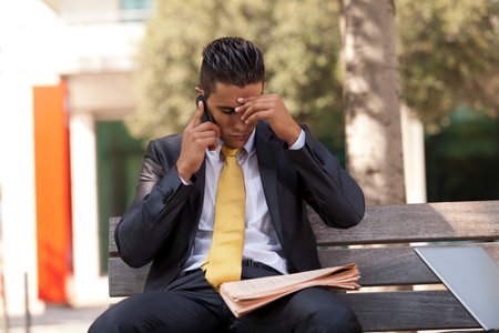 frustrated businessman sit at the bench parkの写真素材