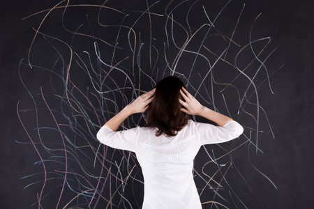 Stressed woman writing in the chalkboard lots of crazy linesの写真素材