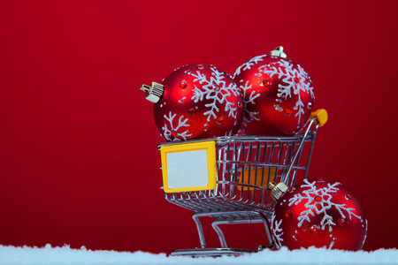 Christmas balls in a shopping cart over a red backgroundの写真素材