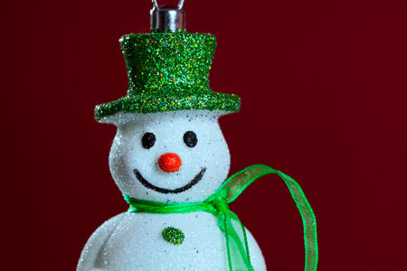 Snowman christmas decoration with red background (selective focus)の写真素材