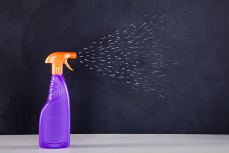 Cleaning products next to a black chalkboardの写真素材