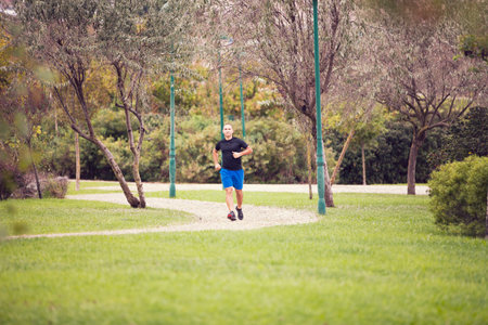 Mature man running at the city parkの写真素材