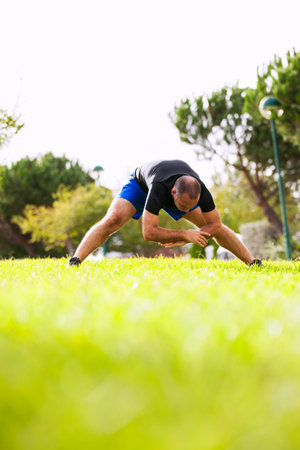 Mature man exercising in a city parkの写真素材