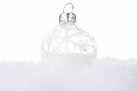 Christmas cold background, with snow and Christmas balls (selective focus)の写真素材