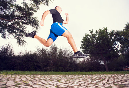 Mature man running at the city parkの写真素材
