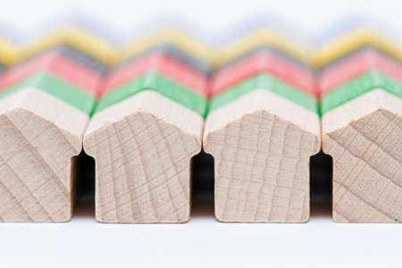 Rows of tiny wooden toy houses painted in different colorsの写真素材