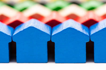 Rows of tiny wooden toy houses painted in different colorsの写真素材