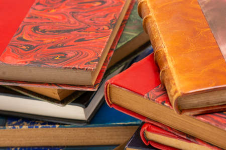 Two stacks of old books with ancient bindings