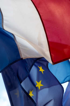 French and European Union flags fluttering together in the wind. Close-up shotの写真素材