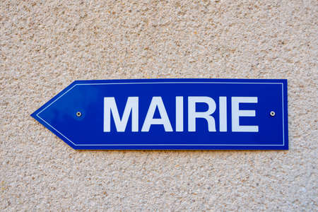 Blue directions sign on which is written the word "town hall" in French language. Close-up shotの写真素材