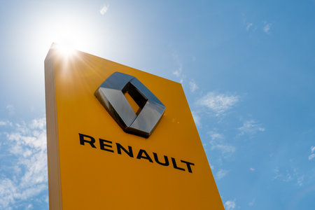 Sign of the French car manufacturing group Renault with its diamond-shaped logo on a yellow backgroundのeditorial素材