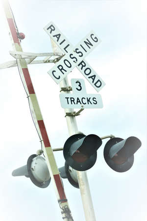 Artistic view of railroad crossing signs and lightsの写真素材